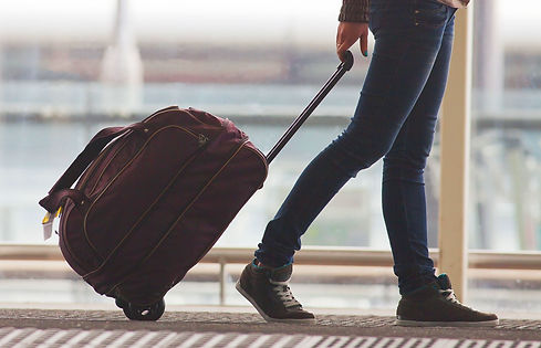 Person Rolling Suitcase in Airport_edite